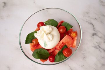 Burrata with tomatoes and basil salad, Italian delicacy, creamy cheese, fresh vegetables