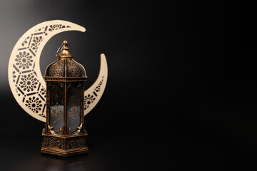 Ramadan Kareem moon and lantern on black background, Islamic faith, traditional Ramadan decor