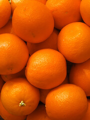 Pile of organic oranges in the market. Fruit orange background. Vertical