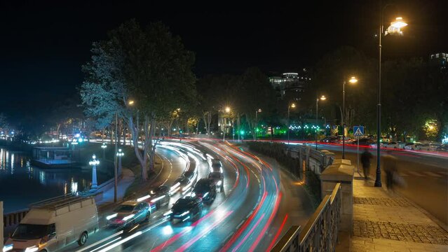 night time illumination Tbilisi city center famous traffic riverside walking pov panorama 4k timelapse georgia 