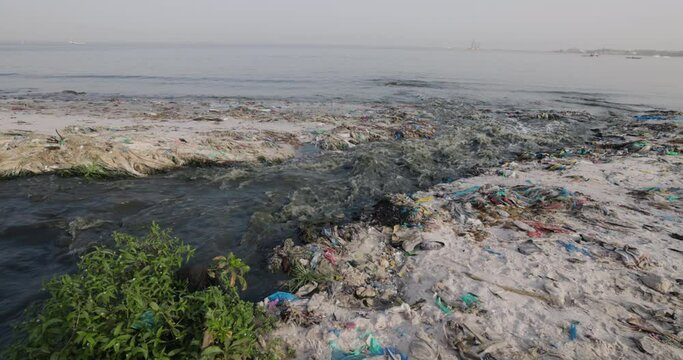 Stinking effluent sewage water and plastic pollution flowing into the ocean.  
