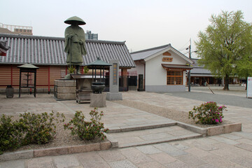 statue of a pilgrim in a shinto temple (shitenno-ji) in osaka in japan 