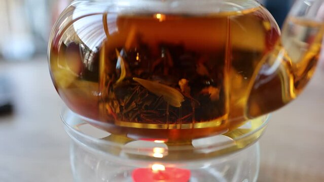 The video features tea leaves gracefully swirling in a teapot, creating a soothing and mesmerizing dance. The gentle infusion captures the essence of tea-making.