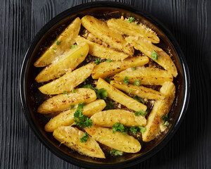 greek lemon potatoes with garlic, cheese on dish