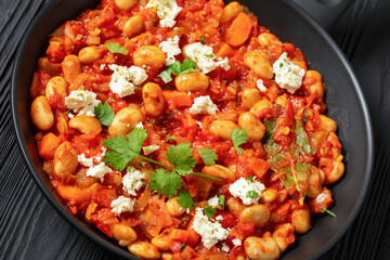 greek giant baked beans with feta on pan