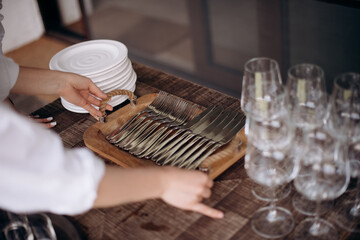 Obraz na płótnie Canvas Tray with cutlery. The waiter serves the table. Catering, restaurant, service. A solemn event