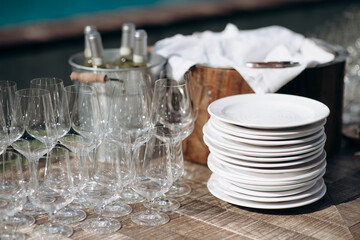 Many empty champagne or wine glasses sparkle in the sun. Preparation for a reception or holiday, a container for alcoholic beverages. Restaurant, catering, service