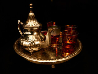 Fototapeta na wymiar An Arab tea set consisted in a decorated platter, a teapot and four glasses