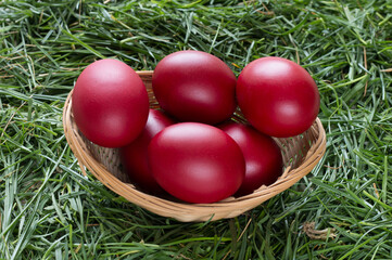 Colorful decorated easter eggs in wicker basket.