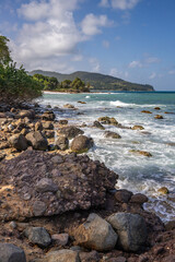 Fototapeta na wymiar Nature in a special landscape. A rocky coast by the sea. Great landscape shot of cliffs in the Caribbean, the waves breaking against the island of Guadeloupe in the French Antilles.