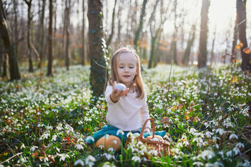 Five year old girl playing egg hunt on Easter