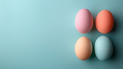 Happy Easter holiday background with colorful pastel eggs on blue paper, top view, copy space