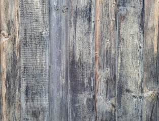 background of old wooden fence panels, faded from the sun and darkened from excess moisture