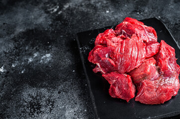 Fresh Raw diced beef veal meat for cooking Shish kebab. Black background. Top view. Copy space