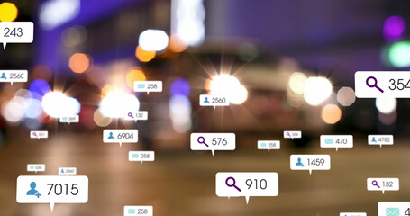 Image of social media icons and numbers on banners over out of focus traffic in city