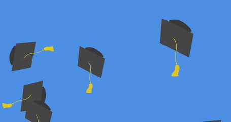 Digital image of multiple graduation hat icons falling against blue background