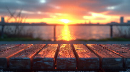 Serene sunset over water viewed from a weathered wooden table on the waterfront.