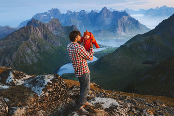 Family travel father hiking with cute baby outdoor in mountains summer vacations active healthy lifestyle trip man with child exploring Lofoten islands in Norway, Fathers day holiday - 749355389
