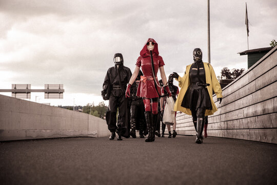A group of people in Latex and Rubber walking fully masked in public