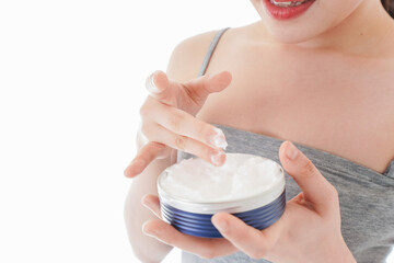 顔にクリームを塗る若い女性