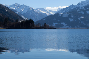 Glistening lake nestled amidst towering mountains, creating a breathtaking scene of serenity and natural beauty.