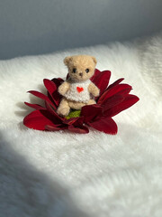 Miniature crochet bear in flower