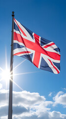 Iconic British Union Jack Flag Fluttering Against Clear Blue Sky - A Symbol of Patriotism and National Identity