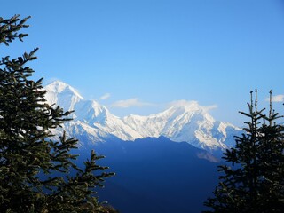 A majestic sight of towering peaks, their jagged outlines merging seamlessly with the endless expanse of the sky.