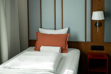 Bedroom modern design with furnishing. Interior of a double bed hotel room. Empty bed with disheveled pillow and sheets.