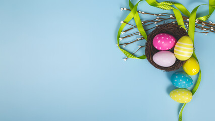 Happy easter banner. Colored Easter eggs on a pastel blue background