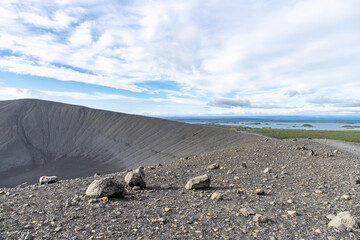 Panoramic view from the top of the tephra cone or tuff ring volcano Hverfjall in Iceland near Lake Myvatn over the rim and crater of the volcano with Lake Myvatn in the background