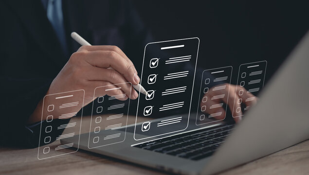 Digital Assessment Concept : Businessman Uses Mobile for Evaluation, Survey Exam, Survey Completion, and Checklist or Fills Assessment Survey for Performance Checklist.	
