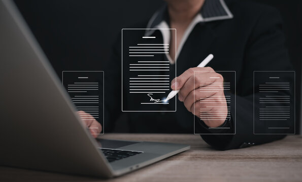 Concepts of practices and policies Company articles association forTerms and Conditions : Businessman using stylus pen to select electronic document on a digital document in a virtual screen to read.