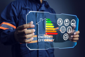Energy labelling concept with engineer holding virtual screen for efficiency rating to improved power consumption of building and residential - obrazy, fototapety, plakaty