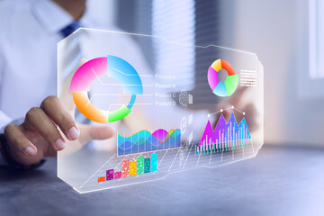 Businessman pointing on virtual analytics dashboard in office desktop