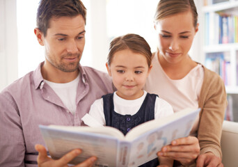 Parents, child and reading at home, sofa and child development in home schooling and bonding. Mom, dad and toddler on couch, living room and smile while learning in book and fairytale stories