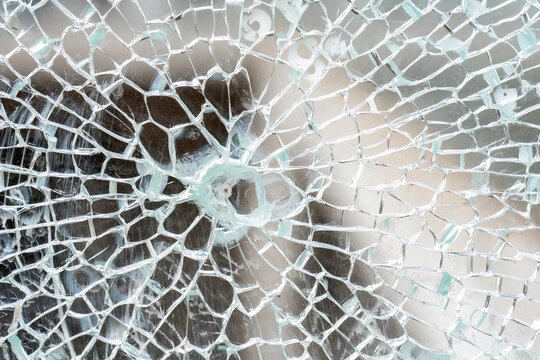 Closeup Detail Macro View Of Cracks Spreading Across A Shattered Glass Panel, Single Point Damage, Broken Tempered Glass, Building Part, Vehicle Window, Safety Glass Breaking Abstract Concept, Nobody