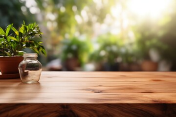Fototapeta premium Wooden Tabletop with Soft Focus on Potted Plant and Clear Jar in Sunny Ambience