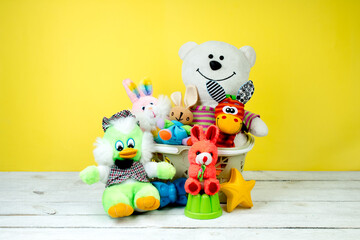 Collection of colorful toys on a yellow background. Kids toys.