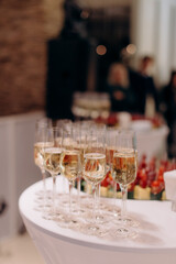 Buffet, glasses of champagne, sparkling wine, sparkling in the sun. Catering, party service. Festive event, welcome drink