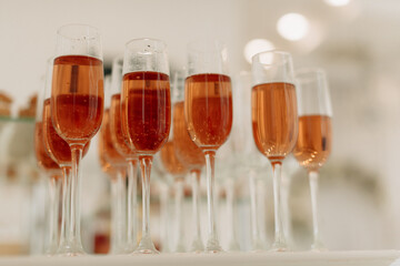 Buffet, glasses of champagne, sparkling wine, sparkling in the sun. Catering, party service. Festive event, welcome drink