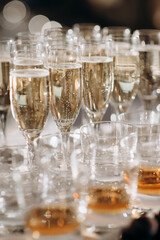 Buffet, glasses of champagne, sparkling wine, sparkling in the sun. Catering, party service. Festive event, welcome drink