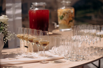 Buffet, glasses of champagne, sparkling wine, sparkling in the sun. Catering, party service. Festive event, welcome drink