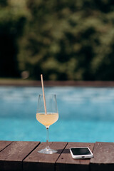 A small tasting glass of sparkling champagne. An unfinished glass of alcohol. Drink champagne or a cocktail. A dirty glass