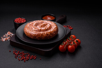 Delicious grilled sausage in the form of a ring with salt, spices and herbs
