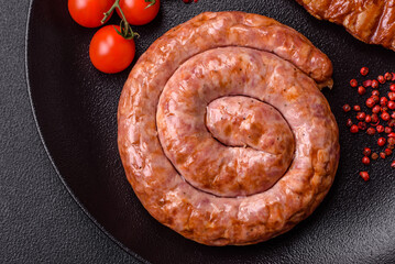 Delicious grilled sausage in the form of a ring with salt, spices and herbs