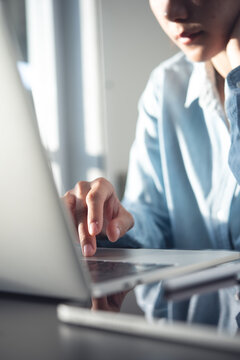 Young asian business woman thinking about problem solving at work. Casual businesswoman searching the information, working on laptop computer