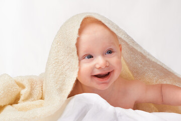 Baby, smile or towel to play, relax or laugh in nursery at bath time in studio on white background. Happy, young child or blanket for peaceful rest for health, hygiene or childhood development