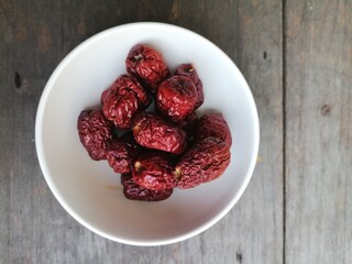 Dried jujube fruit on wood background
