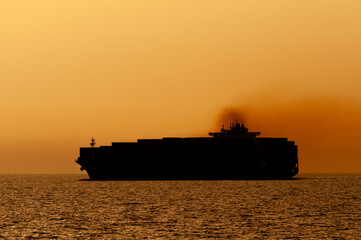 Big - A huge Container Ship enters the Suez Canal from the Mediterranean Sea at dusk. 